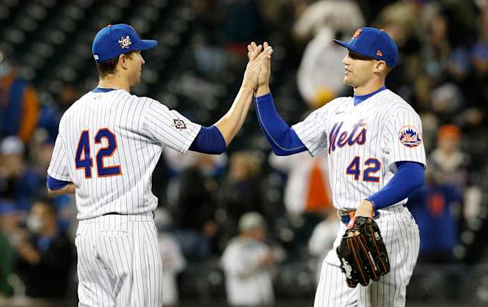 Jacob deGrom #48 (L) of the New York Mets celebrates his shutout against the Washington Nationals with teammate Brandon Nimmo #9 at Citi Field on April 23, 2021 in New York City. All players are wearing the number 42 in honor of Jackie Robinson Day. The Mets defeated the Nationals 6-0.
